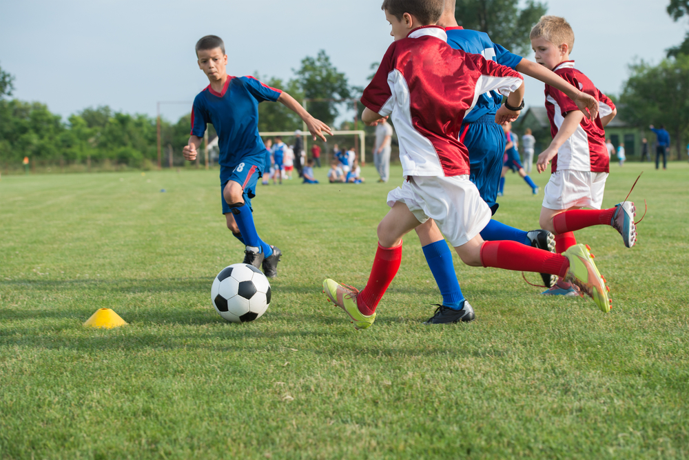Boys,Kicking,Football,On,The,Sports,Field