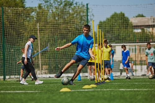 Teamwork,And,Agility.,Young,Soccer,Players,In,Uniforms,Raining,Outdoors